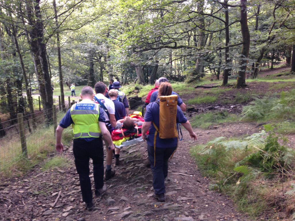 The casualty is carried off the hill to the waiting NWAS Ambulance